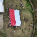 Kirab dan Pengibaran Bendera Merah Putih Raksasa Bukti Kedaulatan NKRI di Distrik Sinak